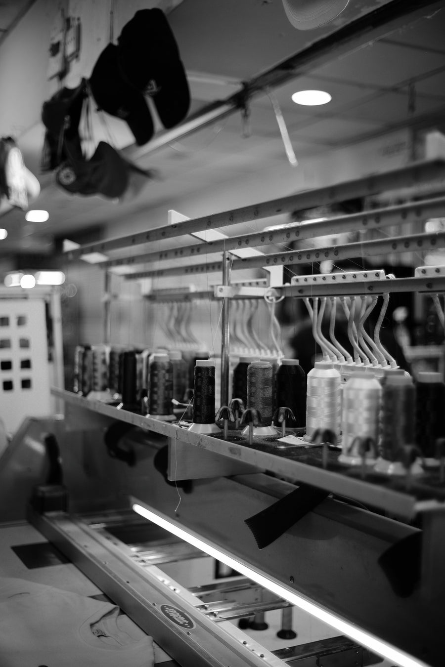Embroidery machine with spools of colored thread