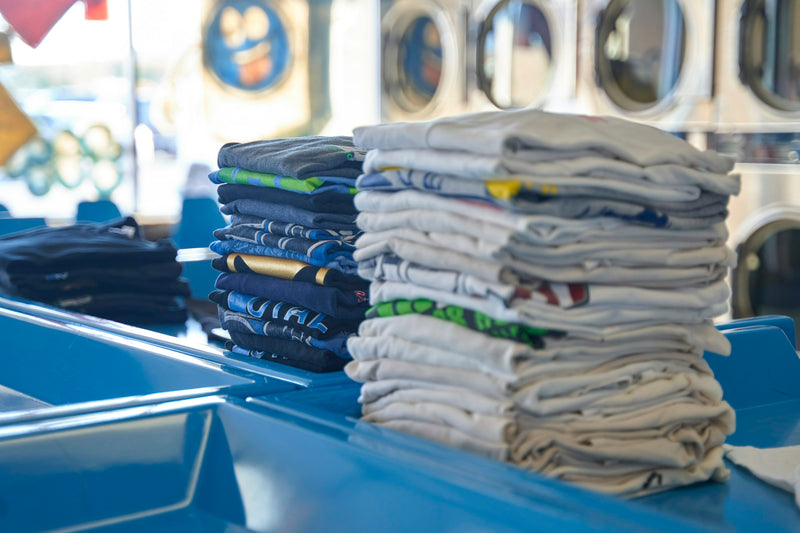 Stack of folded shirts on a blue table